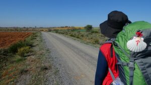 Peregrino con mochila caminando por camino